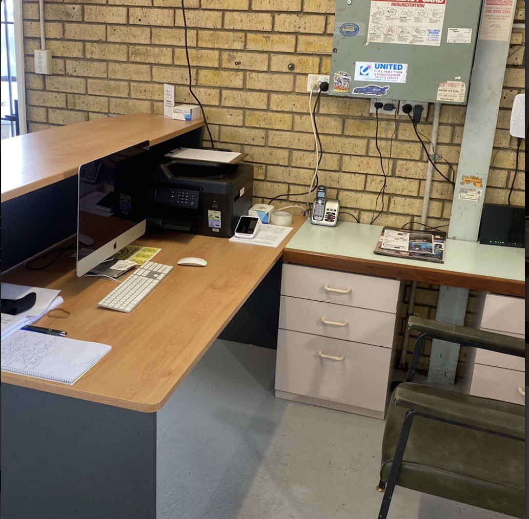 The front office desk with a computer, printer and phone